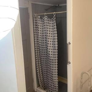a shower curtain in a room with a door at Corella Creek Country Farm Stay in Nelia