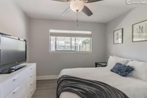 a bedroom with a bed and a flat screen tv at Beautiful 4 bd Mini-Farm Home in Simi with Hot Tub, One Full Bath and One Half Bath in Simi Valley