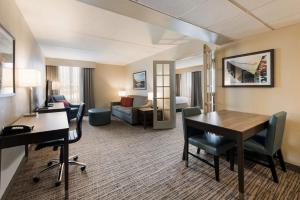 a hotel room with a desk and a living room at Best Western Holiday Lodge in Clear Lake