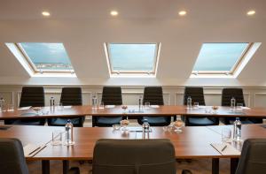 a large room with tables and chairs and windows at Royan Hotel Hagia Sophia, a member of Radisson Individuals in Istanbul