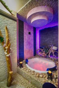 a bathroom with a large tub with purple lighting at Re dream suite a tema - Rapallo in Rapallo