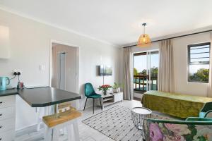 a bedroom with a bed and a desk in a room at Serengeti selfcatering apartments Perfect Stay in Bellville