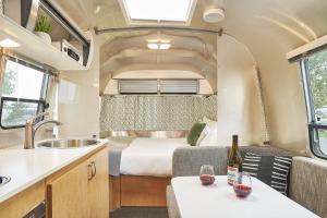 an rv kitchen with a bed and a sink at The Vintages Trailer Resort in Dayton