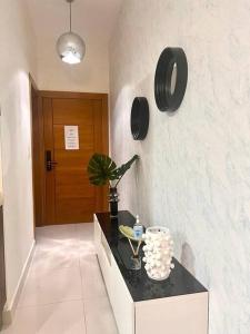 a room with a counter with a plant on a wall at 1BR Luxury apartment Pool, gym, rooftop Santo Domingo in Santo Domingo
