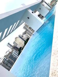 an aerial view of a city and the water at 1BR Luxury apartment Pool, gym, rooftop Santo Domingo in Santo Domingo