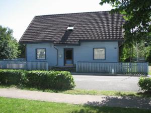 a blue house with a black roof at Arno Apartments in Kuressaare