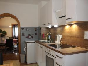 a kitchen with a sink and a counter top at Ferienhaus Rieder in Hopfgarten im Brixental +22 photos