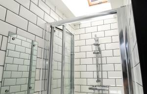 a shower with a glass door in a bathroom at Room in a Shared House, Dean Street, CV2 in London