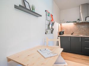 a small kitchen with a wooden table in a room at Tirola Bude Lisi Top 3 in Hopfgarten im Brixental