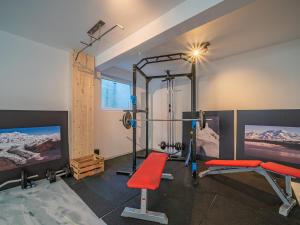 a gym with a treadmill and a simulator at Tirola Bude Lisi Top 3 in Hopfgarten im Brixental