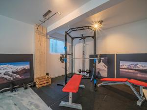 a room with a gym with a treadmill and a tv at Tirola Bude Sepp Top 4 in Hopfgarten im Brixental