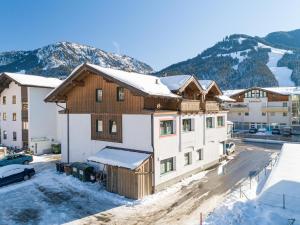 an apartment building with snow on the roof at Apartment Erich Brixen in Brixen im Thale