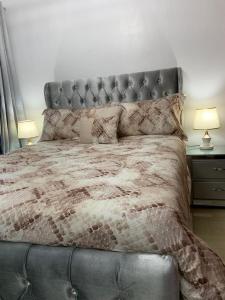 a bedroom with a large bed with a leather headboard at VIP Home in Santiago de los Caballeros