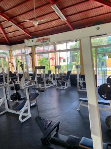 a gym with a bunch of treadms and pilates equipment at VIP Home in Santiago de los Caballeros