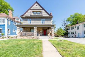 a brick house with a red door on a street at Boutique Apartment in 1905 Victorian Home - Plaza - Westport in Kansas City