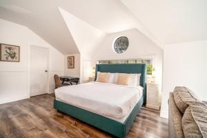 a bedroom with a large bed and a couch at Agate Cove Inn in Mendocino