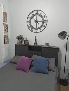 - une chambre avec une grande horloge au-dessus d'un lit dans l'établissement Love Marie, à Tagaytay