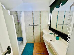 a small bathroom with a sink and a shower at KANOLA Home in Sainte-Anne