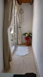 a hallway with an open window with a potted plant at Vistalbahouse in Ciudad Lujan de Cuyo