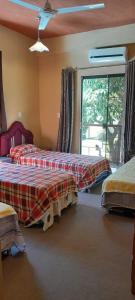 a bedroom with two beds and a window with at Hospedaje San Miguel in Luque