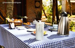 a table with a blue and white checkered table cloth at Chalé Rústico - Retiro Andaluz in Piedade do Paraopeba
