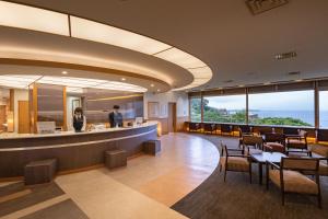 a restaurant with a view of the ocean at KAMENOI HOTEL Atami Annex in Atami