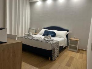 a bedroom with a large bed and a television at Nike Luxury Rooms in Agrigento