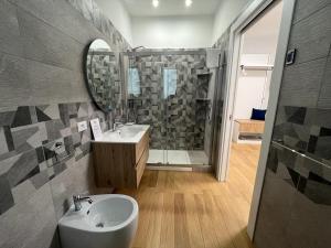 a bathroom with a sink and a shower at Nike Luxury Rooms in Agrigento