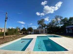 a swimming pool in front of a house at BAHIA de los PESCADORES in Paso de la Patria