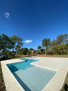 a swimming pool with a blue sky in the background at BAHIA de los PESCADORES in Paso de la Patria
