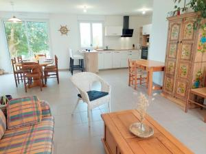 a living room with a kitchen and a dining room at Single storey holiday home in Plouarzel in Plouarzel