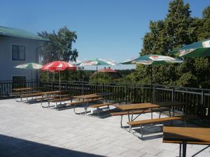 a row of picnic tables with umbrellas at Penzion Velke Darko in Škrdlovice