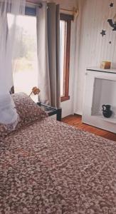 a bedroom with a large bed with a fireplace at CastefadelDiablo in Punta Del Diablo
