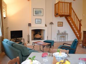 a living room with blue chairs and a fireplace at Gîte Saint-Cybardeaux, 4 pièces, 6 personnes - FR-1-653-70 in Saint-Cybardeaux