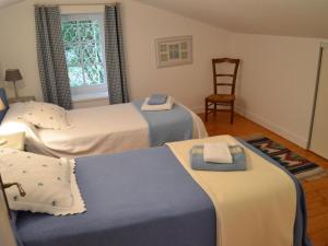 a room with three beds with towels on them at Gîte familial avec piscine chauffée, jardin clos, équipement bébé, au cœur d'une propriété viticole. - FR-1-653-70 in Saint-Cybardeaux +18 photos
