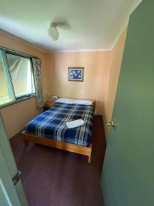 Un pat sau paturi într-o cameră la Kosciuszko Base Camp