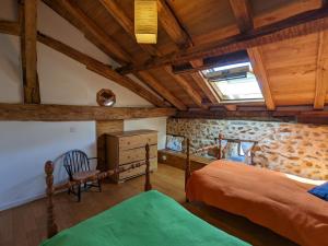 a bedroom with two beds and a wooden ceiling at Gîte Massignac, 4 pièces, 6 personnes - FR-1-653-213 in Massignac