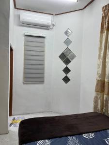 a room with a wall with a window and a mattress at Roomstay Budget Kuala Terengganu Desa Chendering Private Bathroom in Kuala Terengganu