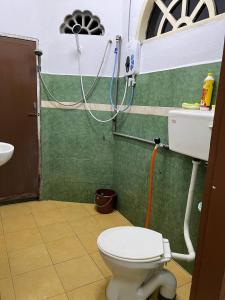 a bathroom with a white toilet and a sink at Roomstay Budget Kuala Terengganu Desa Chendering Private Bathroom in Kuala Terengganu