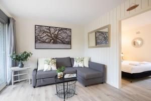 a living room with a couch and a bed at Surfrider 3 in Mollymook