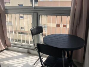 stół i krzesło przed oknem w obiekcie Appartement avec Balcon Proche des Thermes, Étang et Commerces - Climatisé, Animaux Admis - FR-1-503-134 w mieście Balaruc-les-Bains +4 zdjęcia