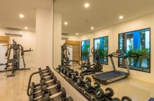 a fitness room with a gym with tread machines at Anda Sea Tales Resort-SHA Plus in Ao Nang Beach