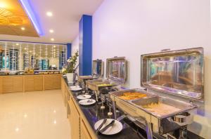 a buffet line with sinks and mirrors in a restaurant at Anda Sea Tales Resort-SHA Plus in Ao Nang Beach