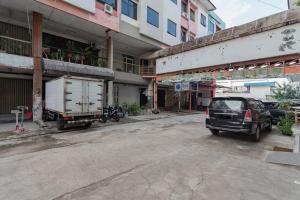 a car parked in a parking lot next to a building at KoolKost near Cihampelas Walk in Bandung