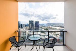 a balcony with a table and chairs and a view at Hope Street Apartments by CLLIX in Brisbane
