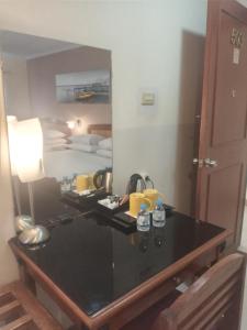 a desk in a room with a mirror at Hotel Celebes in Manado +31 photos