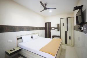 a bedroom with a bed and a ceiling fan at HOTEL K FORT in Jalandhar