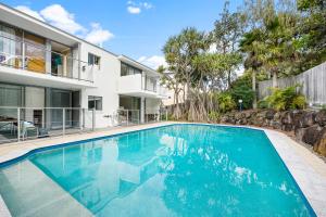 a swimming pool in front of a house at Moments from the Beach, Sunrise Beach in Sunrise Beach