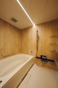 a bathroom with a large tub and a shower at Yuhi House Kyoto Dog Friendly in Kyoto