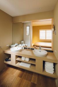 a bathroom with two sinks and a large mirror at Yuhi House Kyoto Dog Friendly in Kyoto